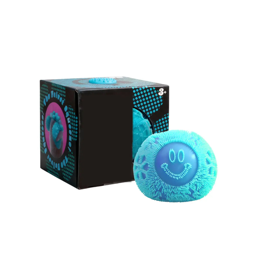 Blue smiley face ssquish toy next to its packaging on a white background