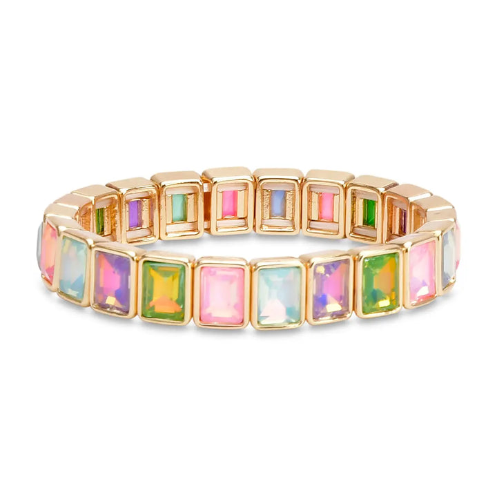 A gold-plated stretch bracelet featuring rectangular iridescent cabochon gemstones in pink, green, blue, and purple, set against a plain white background.
