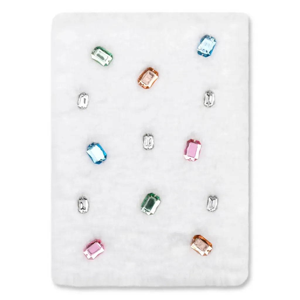 A white rectangular dnotebook showing multiple small rectangular gemstones in assorted colors, including blue, green, pink, orange, and clear/white stones, arranged on a light gray background.