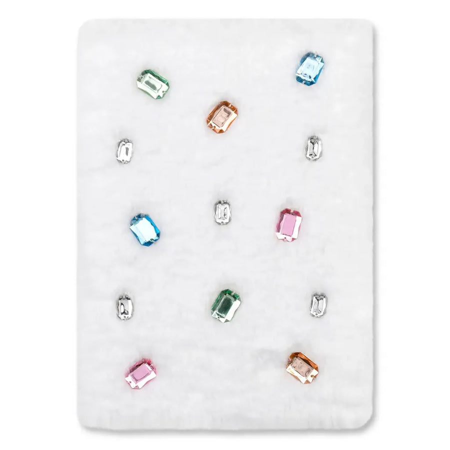 A white rectangular dnotebook showing multiple small rectangular gemstones in assorted colors, including blue, green, pink, orange, and clear/white stones, arranged on a light gray background.