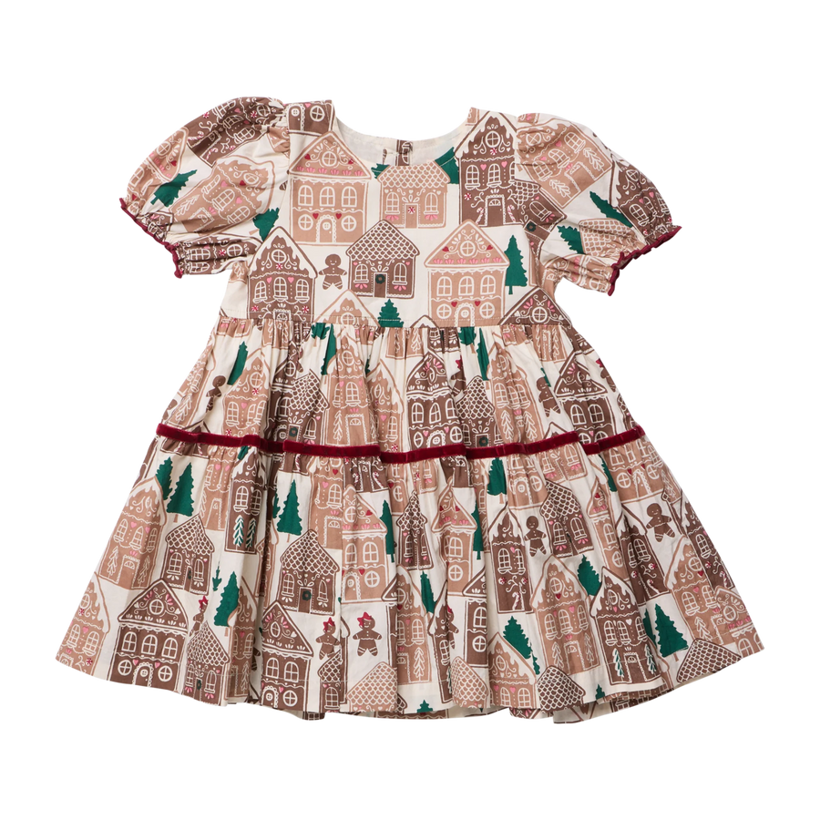 A toddler girl's short-sleeve dress with a festive gingerbread house print, featuring puff sleeves, a tiered skirt, and a dark red ruffled trim at the waist, shown against a plain white background.