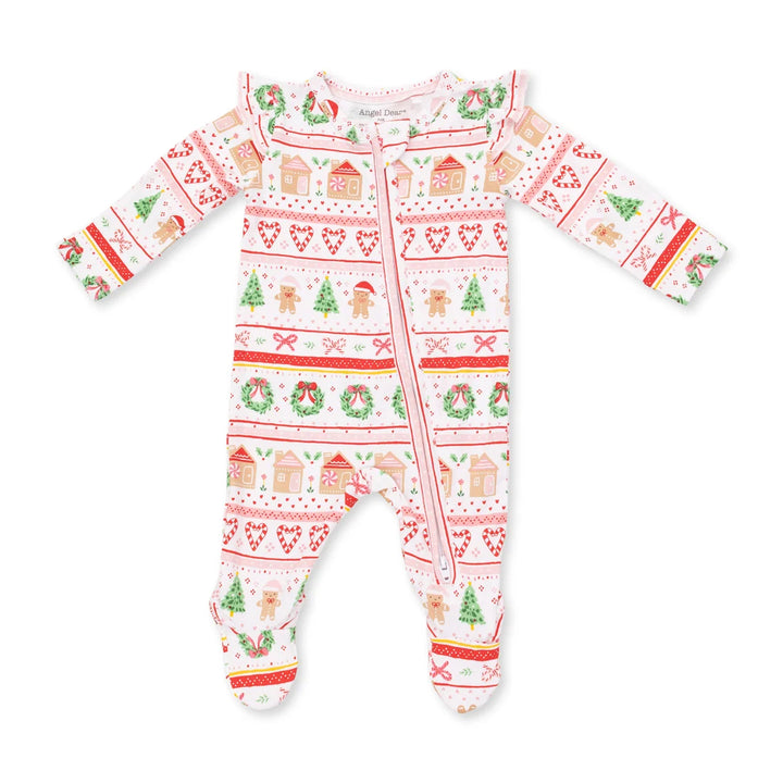 A baby footed sleeper with long sleeves and a front zipper, featuring a festive Christmas pattern with gingerbread houses, wreaths, candy canes, and trees on a white background.
