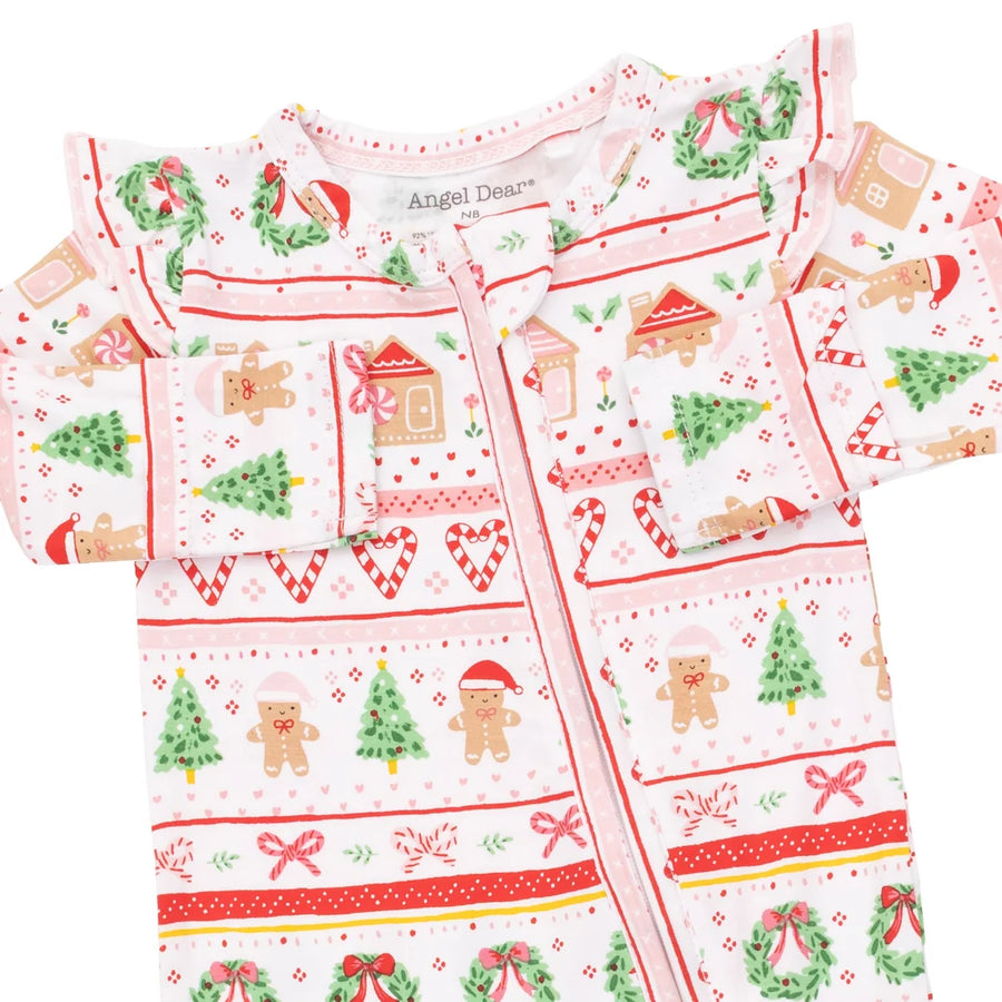 A baby zip-up sleeper or onesie with a festive Christmas print, featuring gingerbread men, trees, wreaths, and candy canes on a white background. The brand name 'Angel Dream' is visible on the inner neck label.