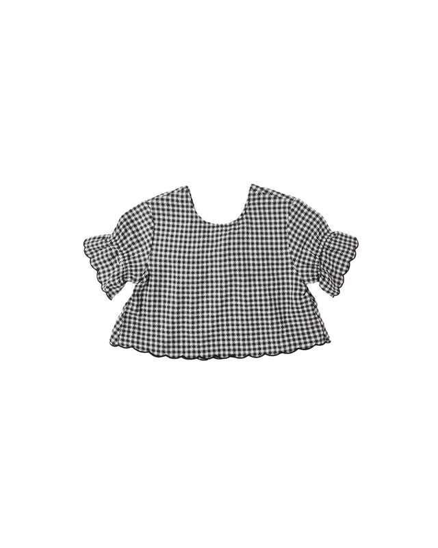 Black and white checkered blouse with ruffle at the edge of the sleeve  on a white background