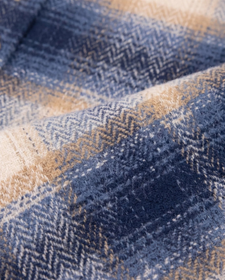 close up of the textured fabric in colors in the shirt: navy, beige and tan