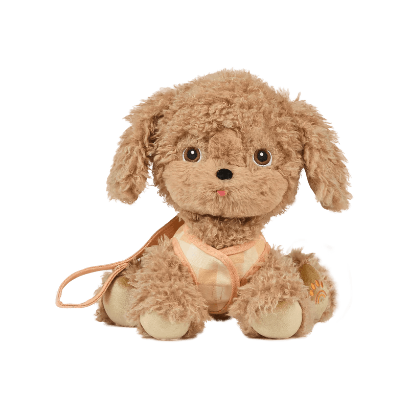 stuffed animal dog that looks like a puppy with floppy ears and golden fur with a lead attached. 