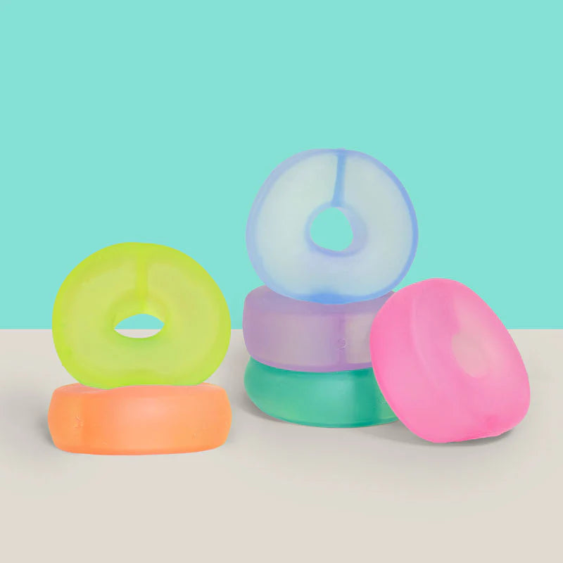 Colorful donut-shaped squish toys. 6 different colors: blue, pink, green, purple, yellow and orange