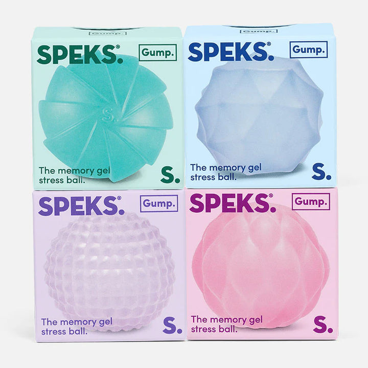 Four Speks memory gel stress balls in different colors with packaging on a white background.