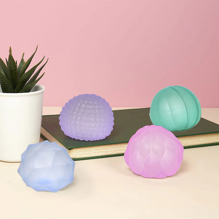 assorted colors of textured aquish balls: pink, blue, teal and purple