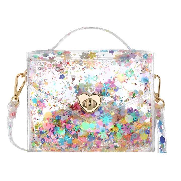 Jelly tote with detachable strap and multi colored confetti inside the transparent tote. 