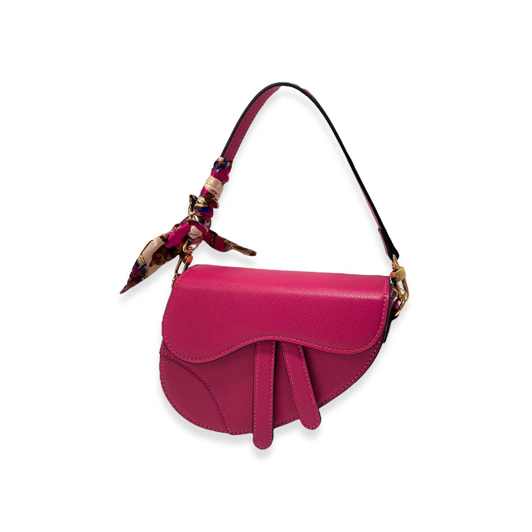 fuschia color purse having a saddle shape with shoulder strap. 