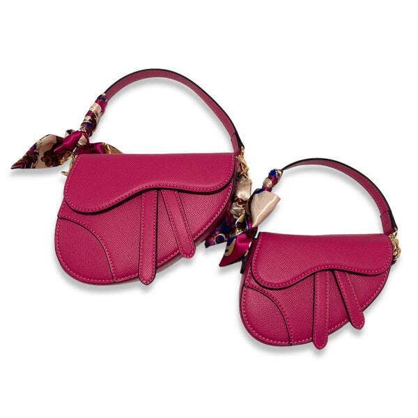 2 sizes of the saddle bag, one large and one small. fuschia color with scarf attached to the shoulder strap. 