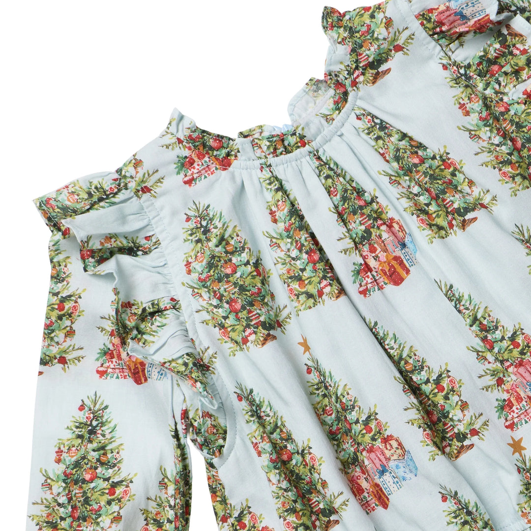 A close-up of a light blue long-sleeve dress with a festive Christmas tree print, featuring ruffled shoulders and a gathered neckline.