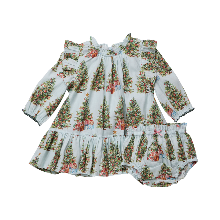 A baby girl's two-piece outfit featuring a long-sleeve smocked dress and matching bloomers, both printed with a festive Christmas tree pattern on a pale blue background.