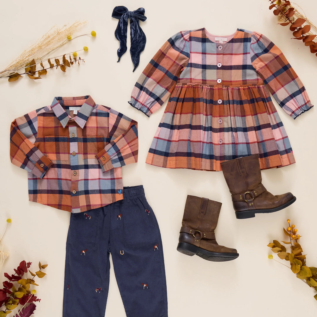 picture of long sleeve plaid dress and matching young boy collared shirt and navy pants. 