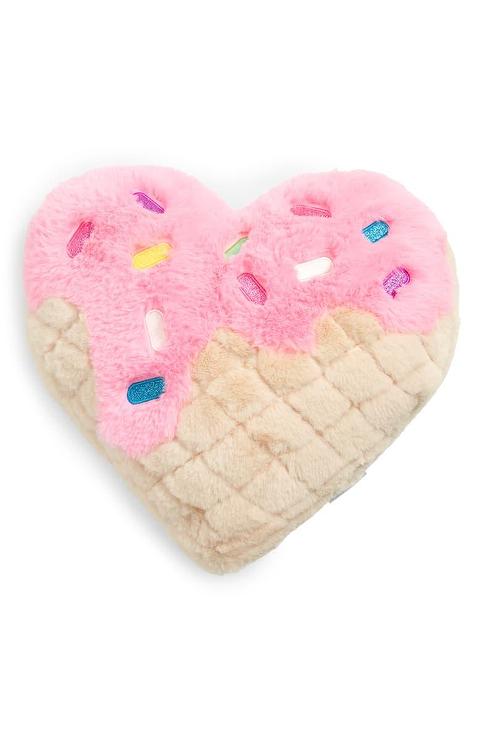 heart shaped waffle pillow with pink icing and rainbow sprinkles. 