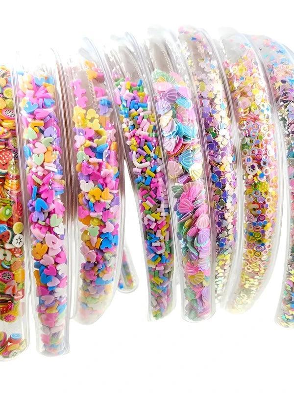 Transparent Headbands filled with different kinds of shapes: sprinkles, hearts, shells and fruit. 