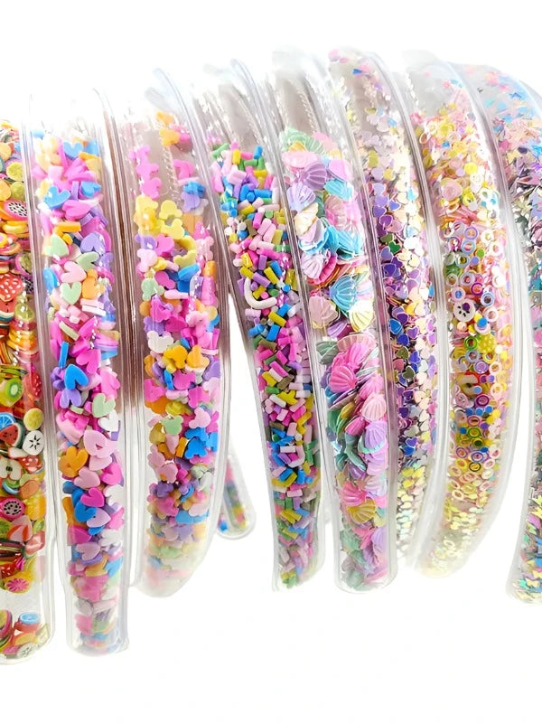 Transparent Headbands filled with different kinds of shapes: sprinkles, hearts, shells and fruit. 