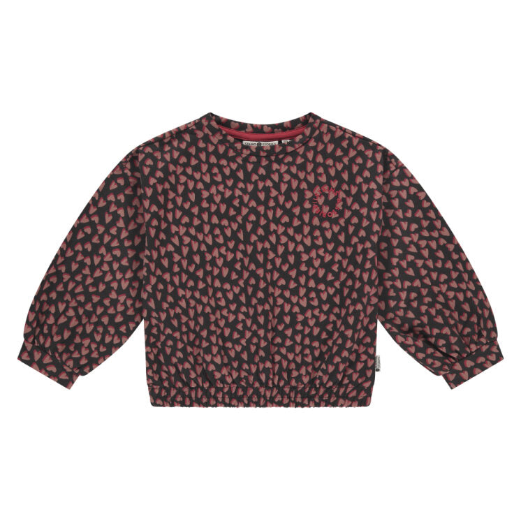 Red and black patterned sweater on a white background