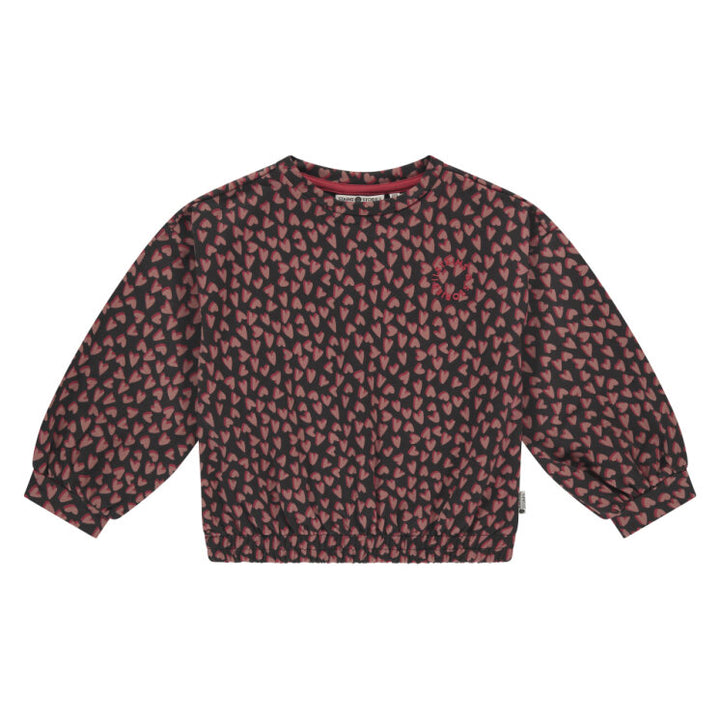 Red and black patterned sweater on a white background