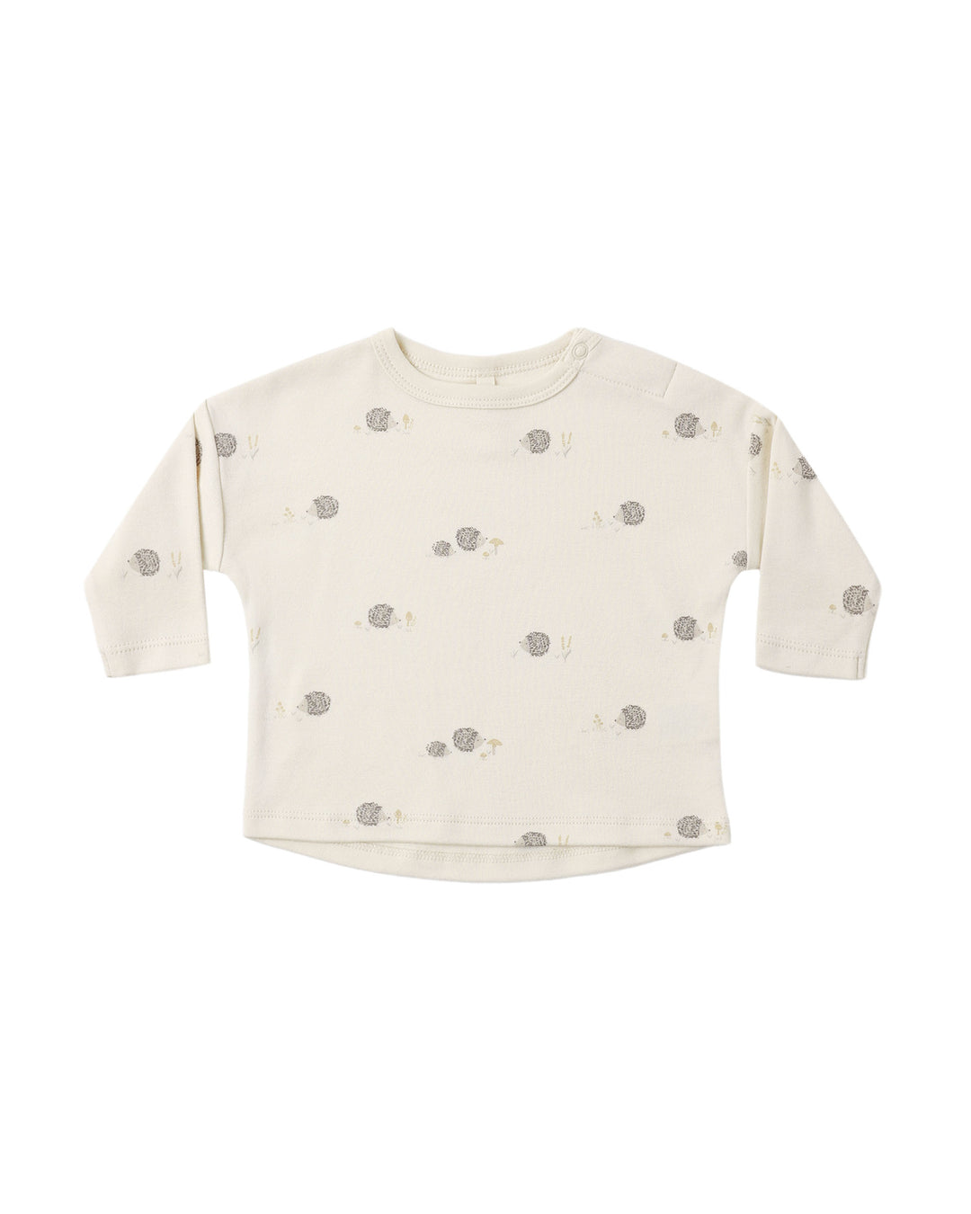An off-white long-sleeve baby top with a small all-over print of gray hedgehogs and tiny yellow accents, displayed flat against a solid white background.