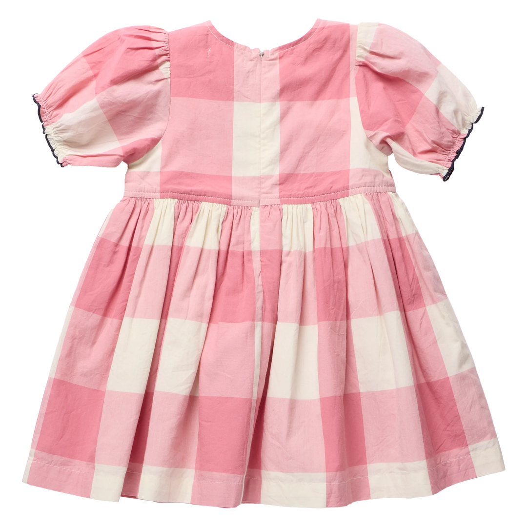 A pink and off-white gingham check dress for toddlers, featuring short puff sleeves with black lace trim, a gathered waist, and a pleated skirt, shown against a plain white background.