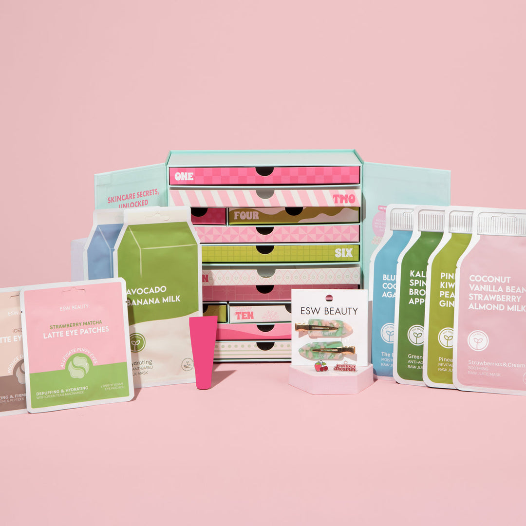 Collection of skincare products and drawers on a pink background