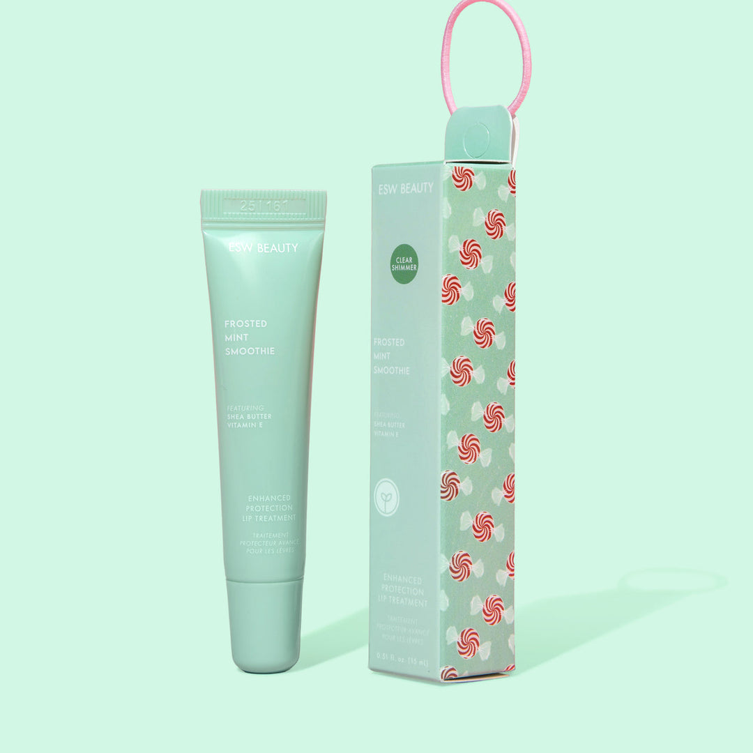 lip balm tube and packaging with candy cane pattern on a light green background