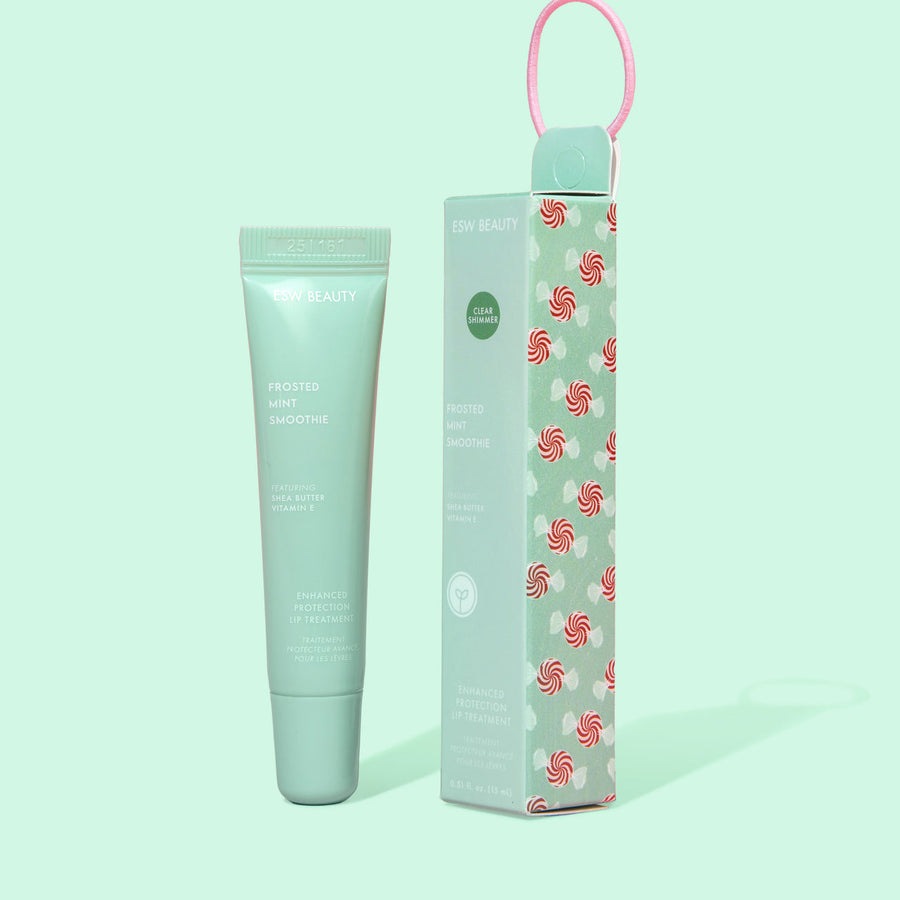 lip balm tube and packaging with candy cane pattern on a light green background