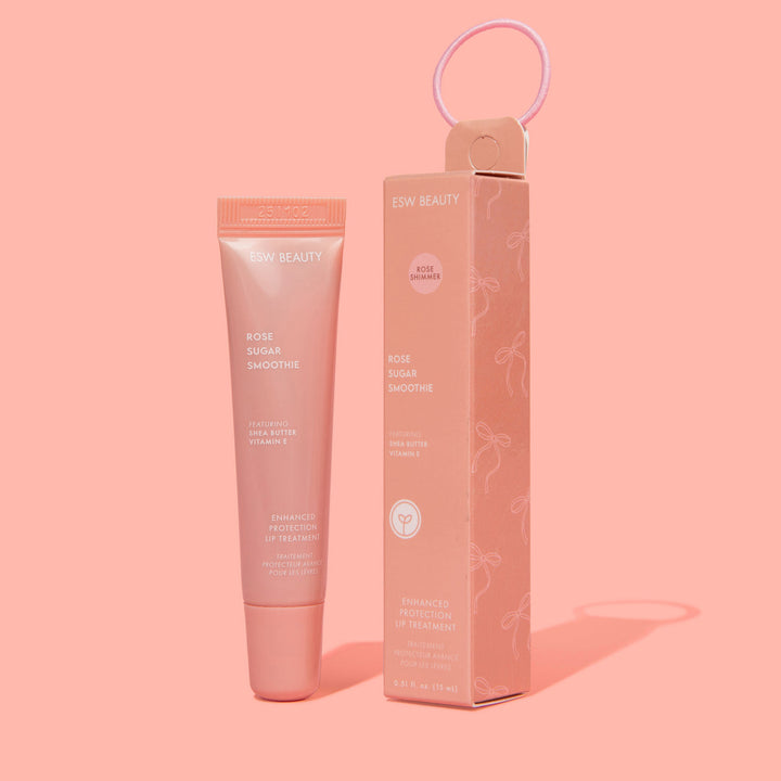 Pink skincare tube and packaging on a pink background
