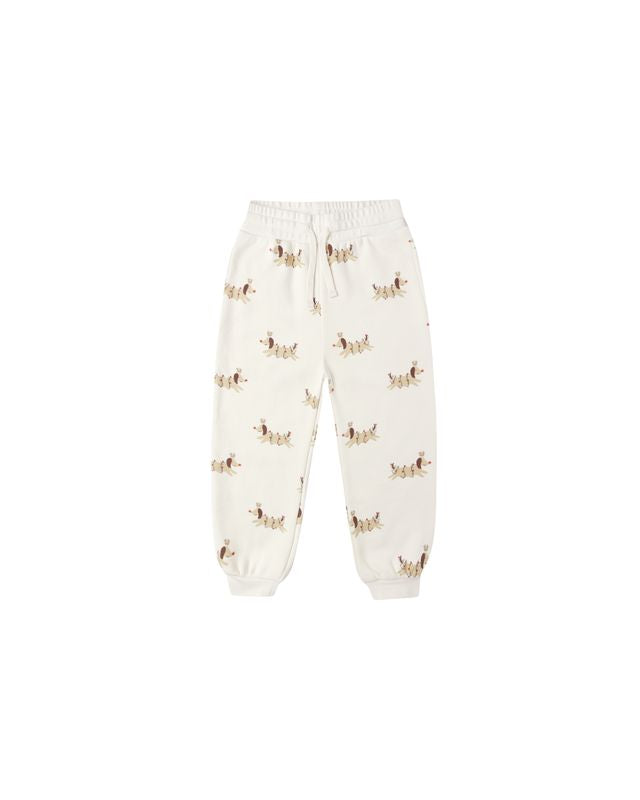 beige sweatpants with christmas dog pattern on a white background