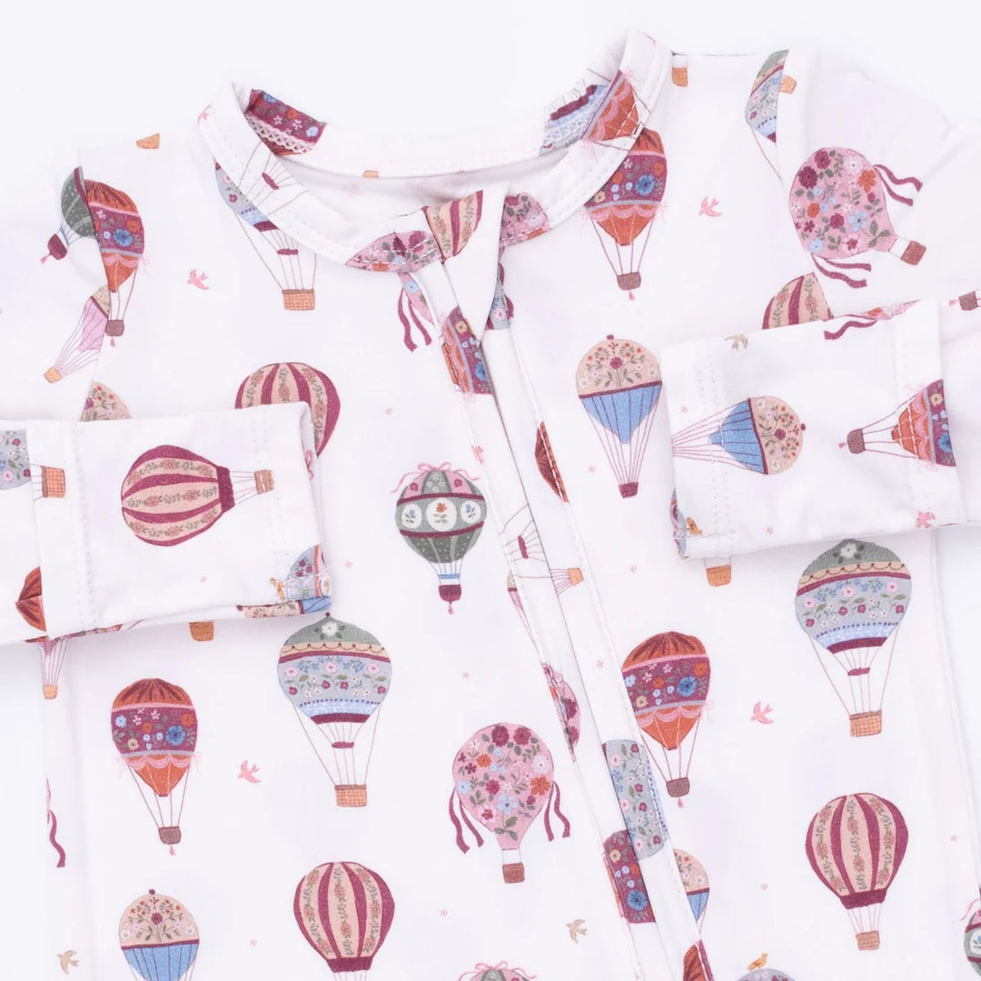 baby footie with colorful hot air balloon pattern on a white background