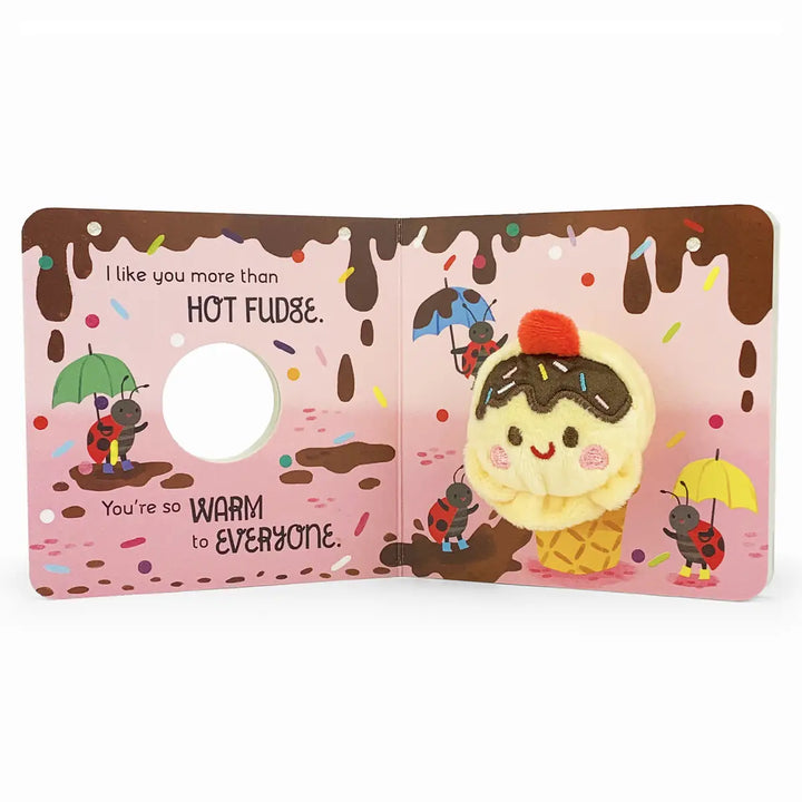A children's pop-up board book featuring a cute ice cream cone character popping up on the right page, with text on the left page that reads, 'I like you more than HOT FUDGE. You're so WARM to EVERYONE.