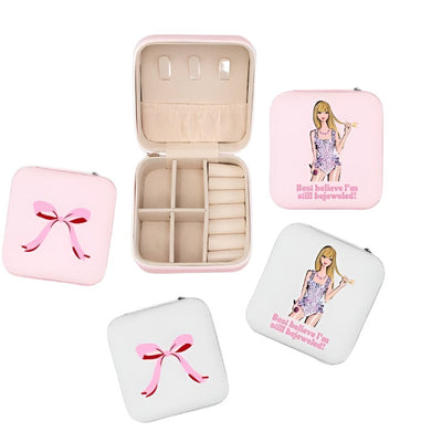 travel size jewelry box with Taylor Swift on the top. The words read " Best Believe I'm still bejeweled". The jewelry case comes in pink and white. The inside has places for rings and four dividers for whatever you like.  