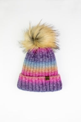 rainbow beanie tan pom pom on top of hat