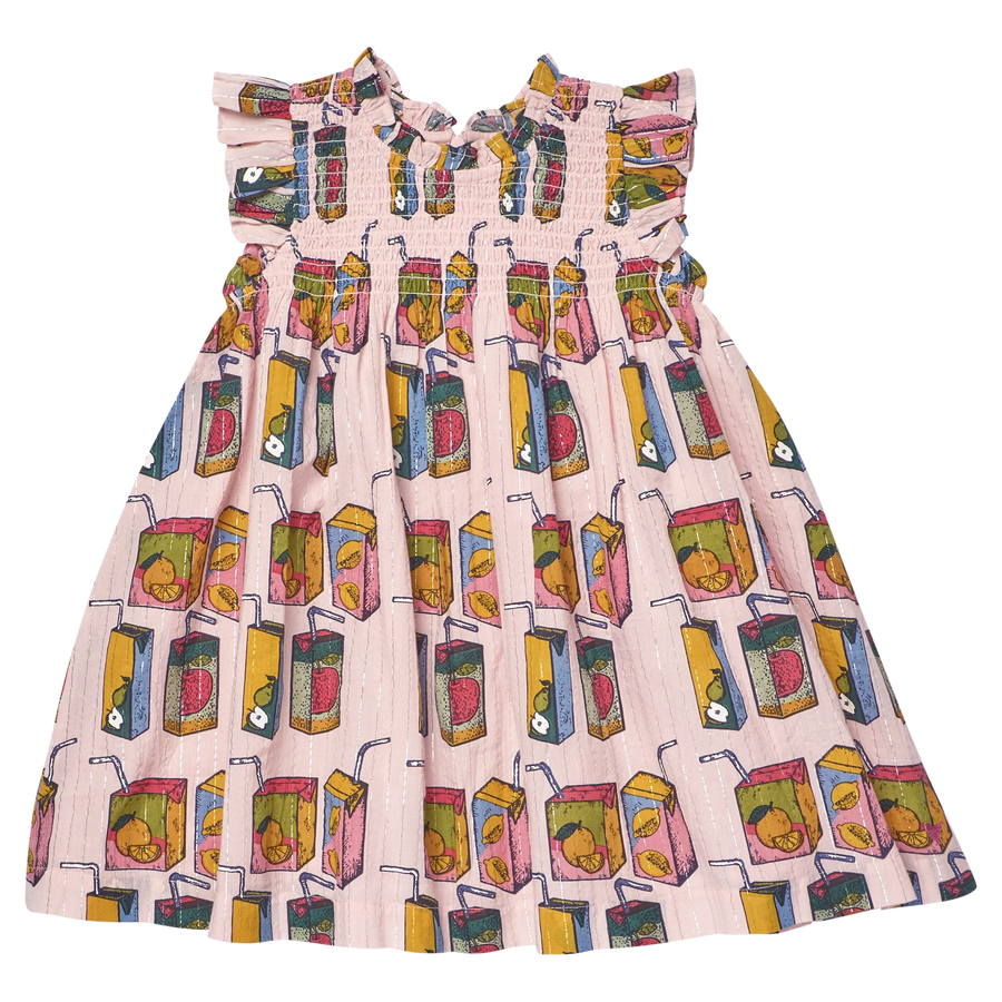 A sleeveless kid's dress with ruffled shoulder straps and a smocked bodice, featuring a pink and white striped base with a colorful print of juice carton illustrations.