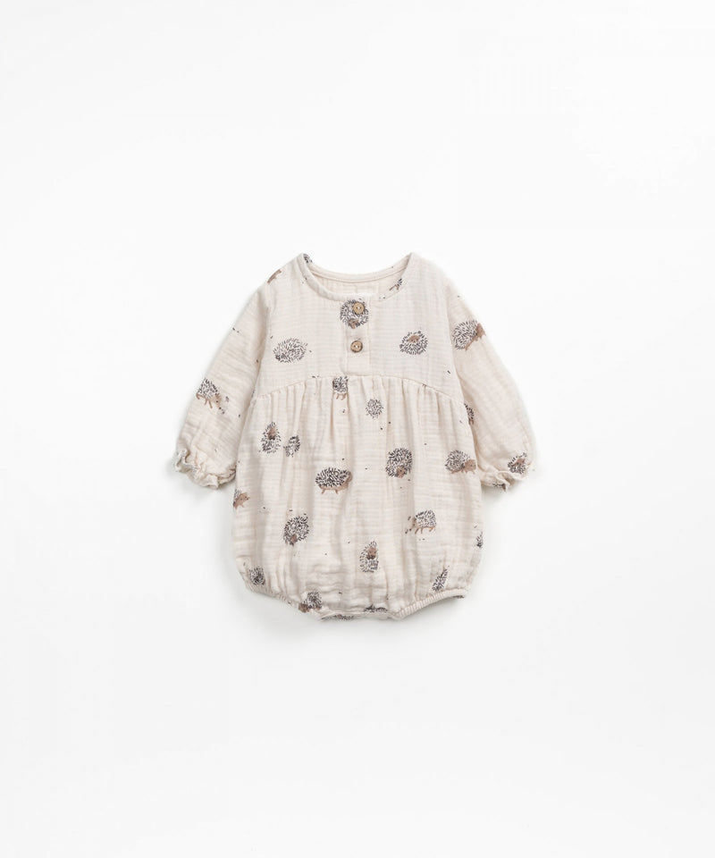 baby jumpsuit. beige in color with tiny hedgehogs all over 