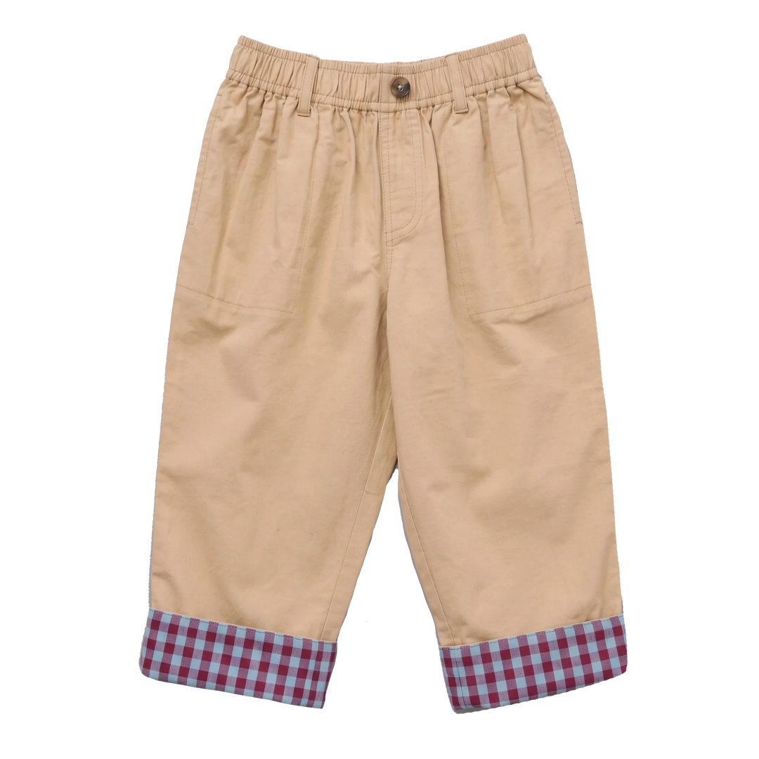 A pair of beige cropped pants with an elastic waistband, side pockets, and a red and blue gingham checkered cuff lining, shown against a plain white background.