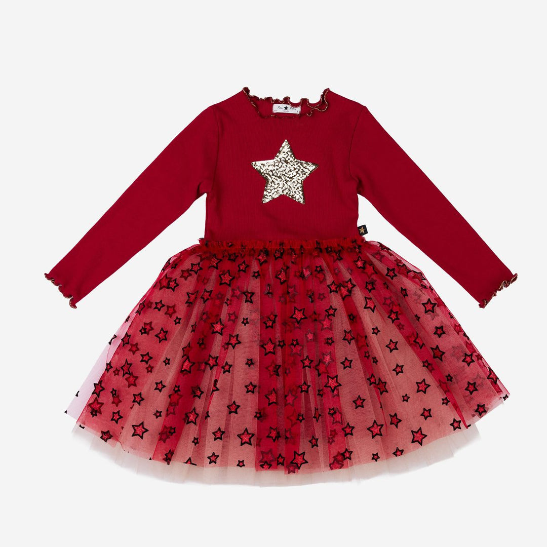A toddler girl's long-sleeve dress featuring a solid deep red top with a glittery silver star on the chest, and a layered red tulle skirt decorated with black star patterns.