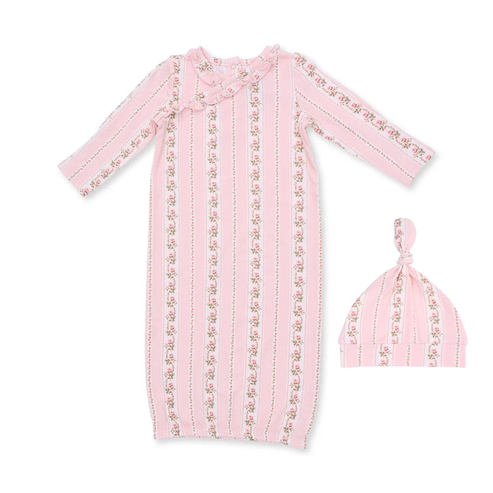 A baby sleep suit and matching knotted beanie hat in light pink fabric with vertical stripes and small floral prints, shown on a plain white background.