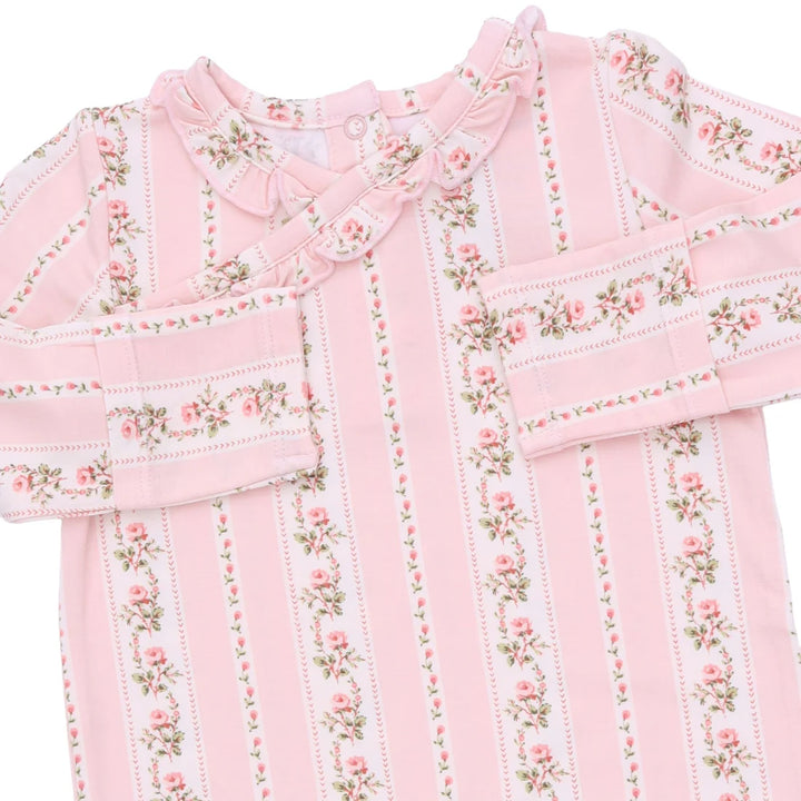A pink long-sleeve baby top with vertical stripes, floral rose patterns, and a ruffled collar, shown on a plain white background.