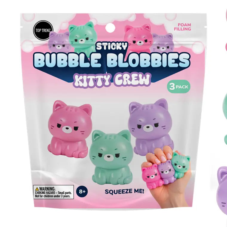 A 3-pack of 'Sticky Bubble Blobbies Kitty Crew' foam filling squishies in pink, mint green, and purple, shown in its retail packaging with a hand holding the assembled toys.
