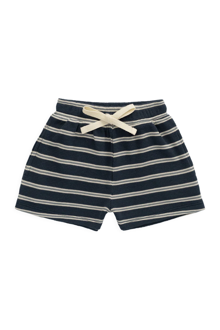 A pair of children's shorts with horizontal navy blue and cream stripes, featuring an elastic waistband and a matching cream bow, shown against a plain white background.