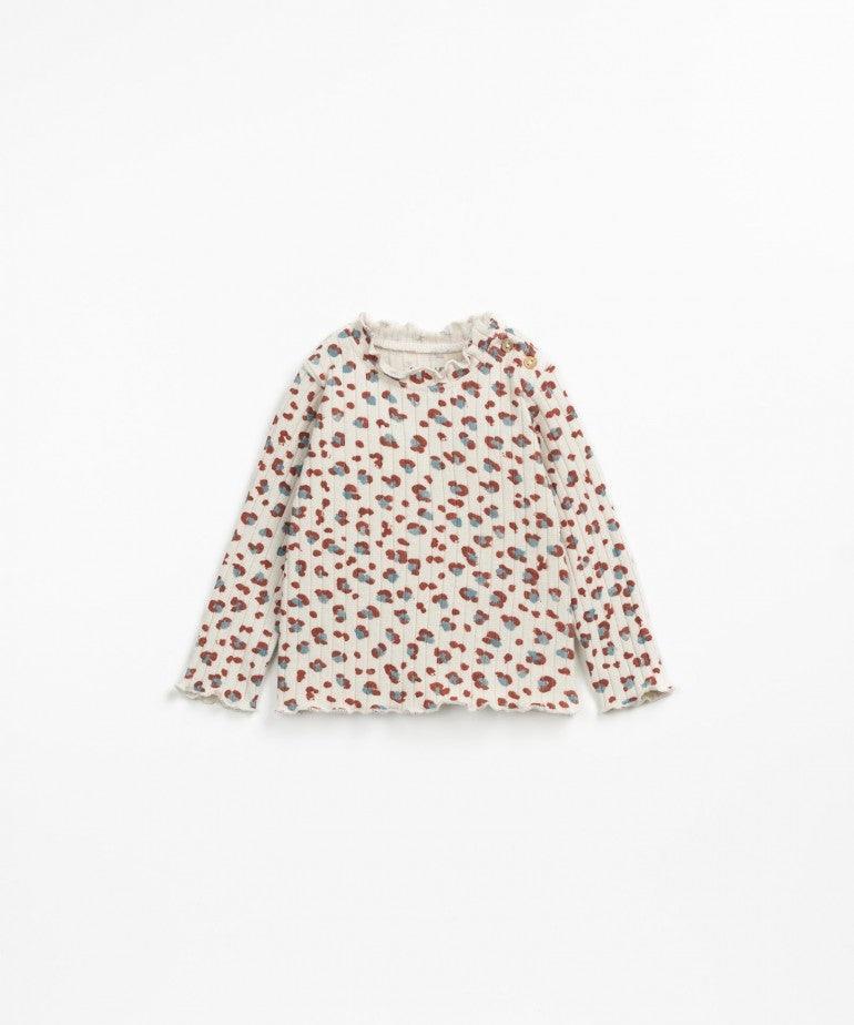 Beige baby long sleeve top. leopard print with blue and rust colors in the spots