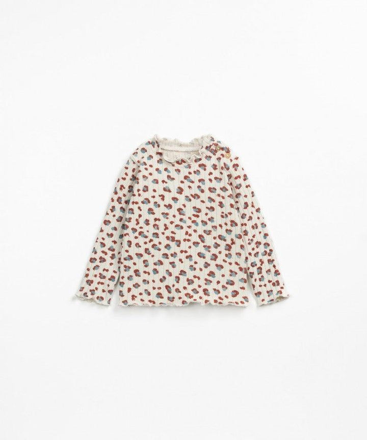 Beige baby long sleeve top. leopard print with blue and rust colors in the spots