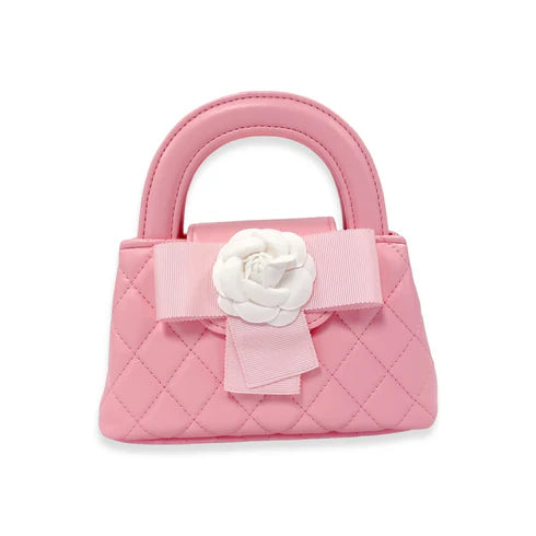 Pink quilted handbag with a white flower and bow 