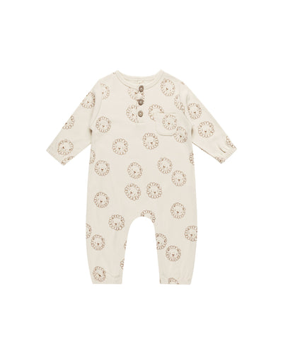 beige jumpsuit with tan lion faces all over it. 