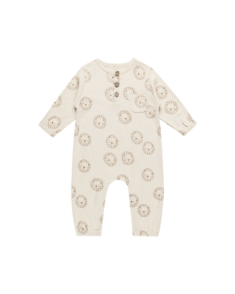 beige jumpsuit with tan lion faces all over it. 