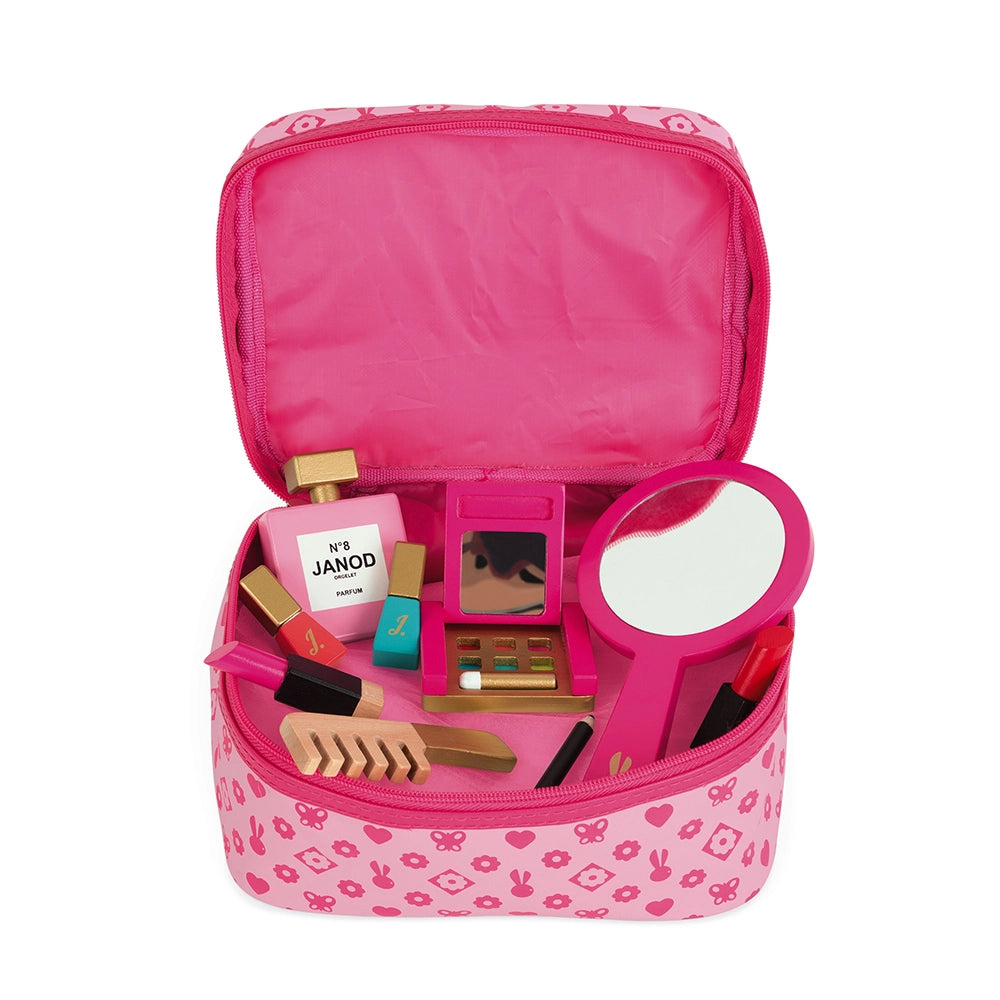 Pink makeup bag with toys and accessories on a white background