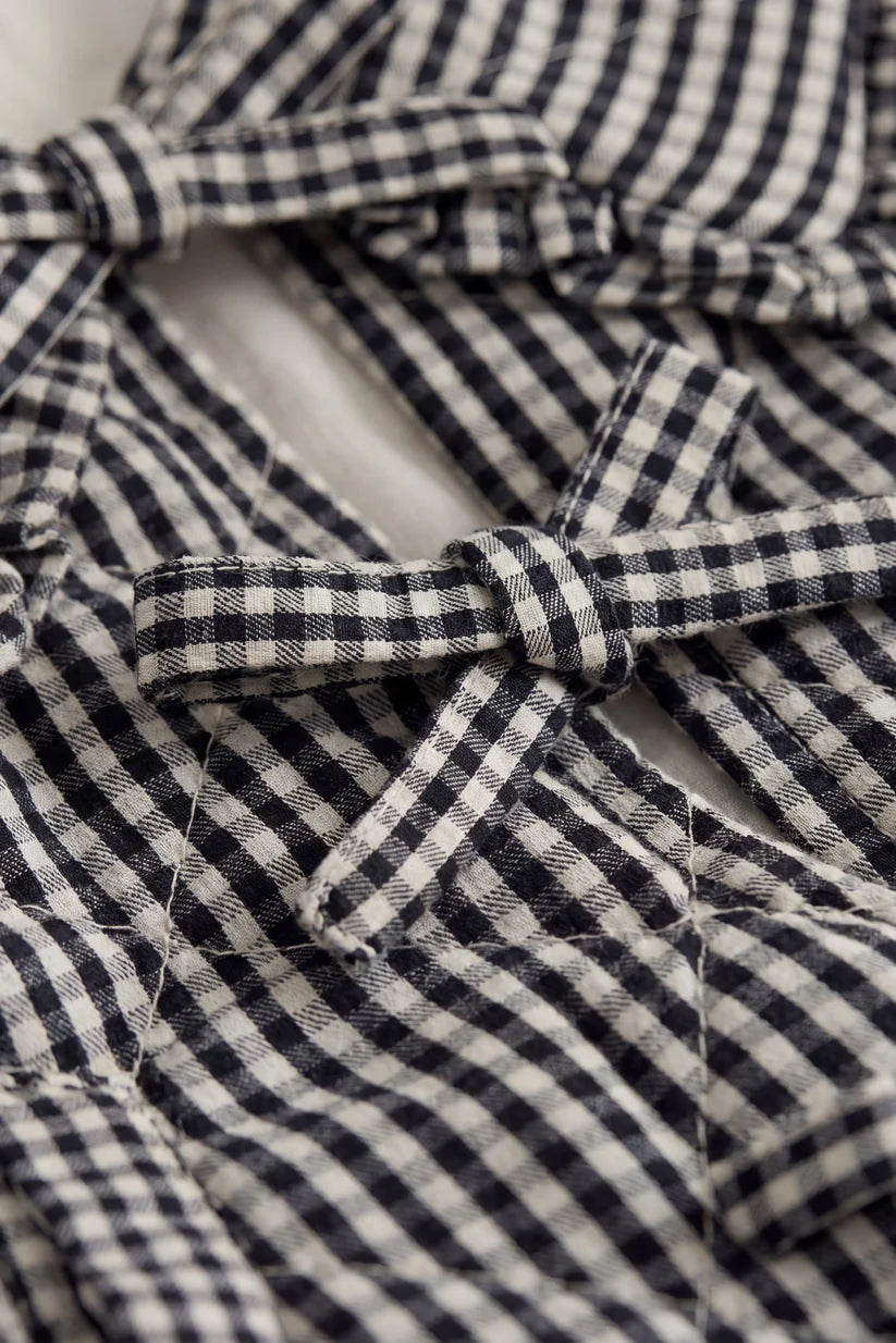 Close-up of a black and white checkered fabric with a bow